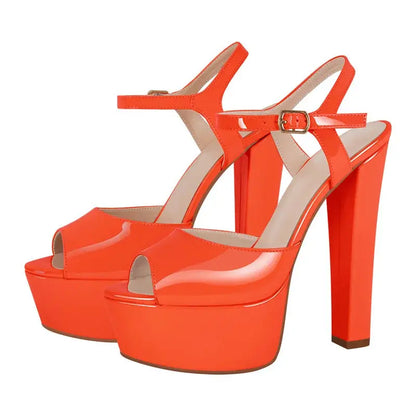 Orange high-heeled platform shoes on a white background
